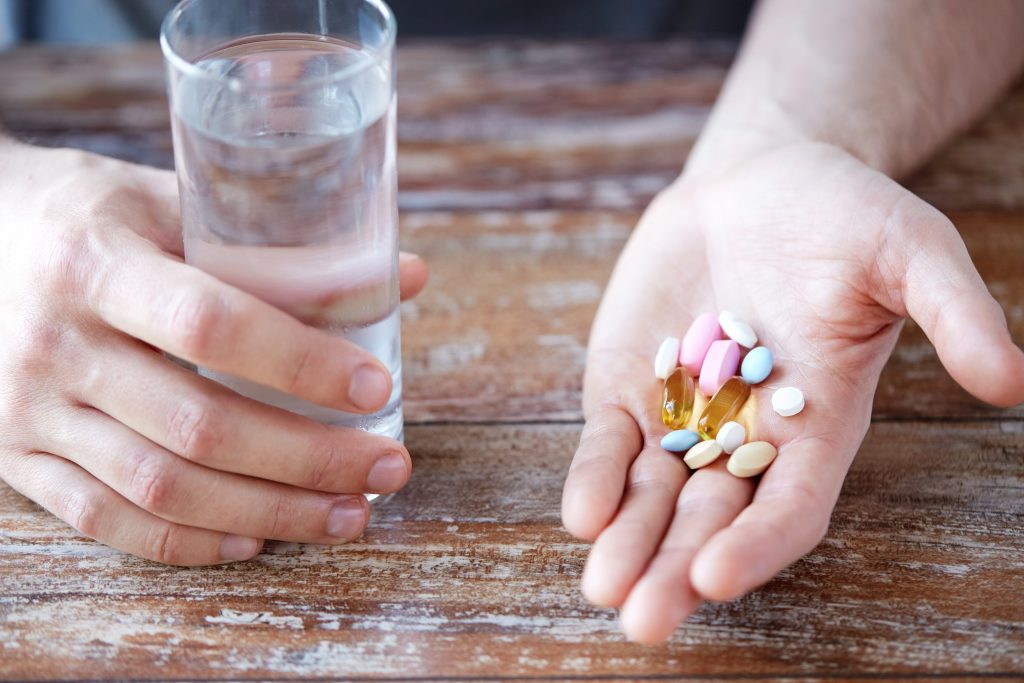 man taking vegans supplements